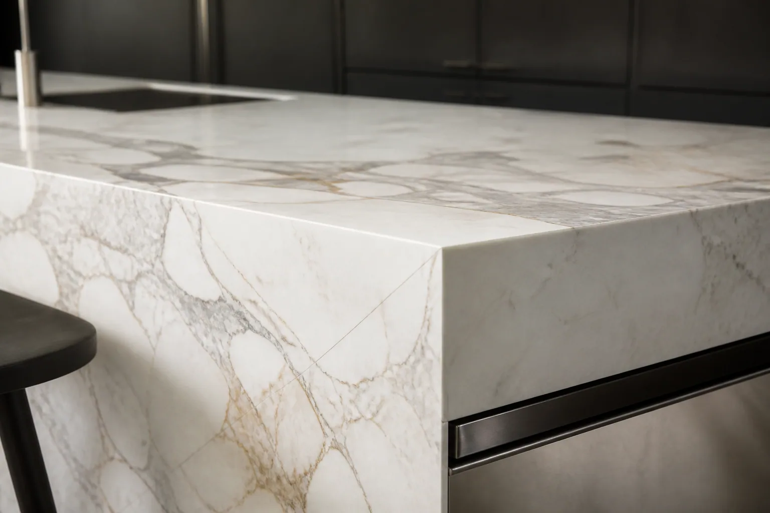 Bookmatched Calacatta marble waterfall island detail
